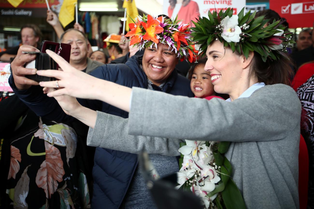 New Zealand's Prime Minister Jacinda Ardern takes pictures with supporters during a campaign outing at Mangere town centre and market in Auckland, New Zealand, October 10, 2020.