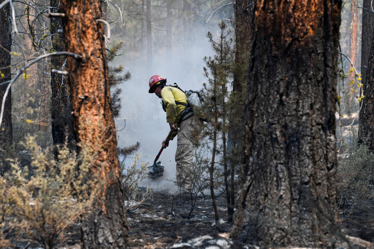 Firefighter Garrett Suza tamps down hotspots in the northwestern section of the Bootleg Fire in Oregon, which affected more than 400,000 acres, in Klamath Falls, Oregon, U.S., July 14, 2021