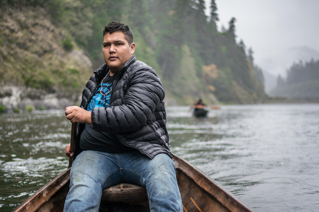 Samuel Gensaw, an enrolled member of the Yurok Tribe, canoes on the Klamath River in Northern California.