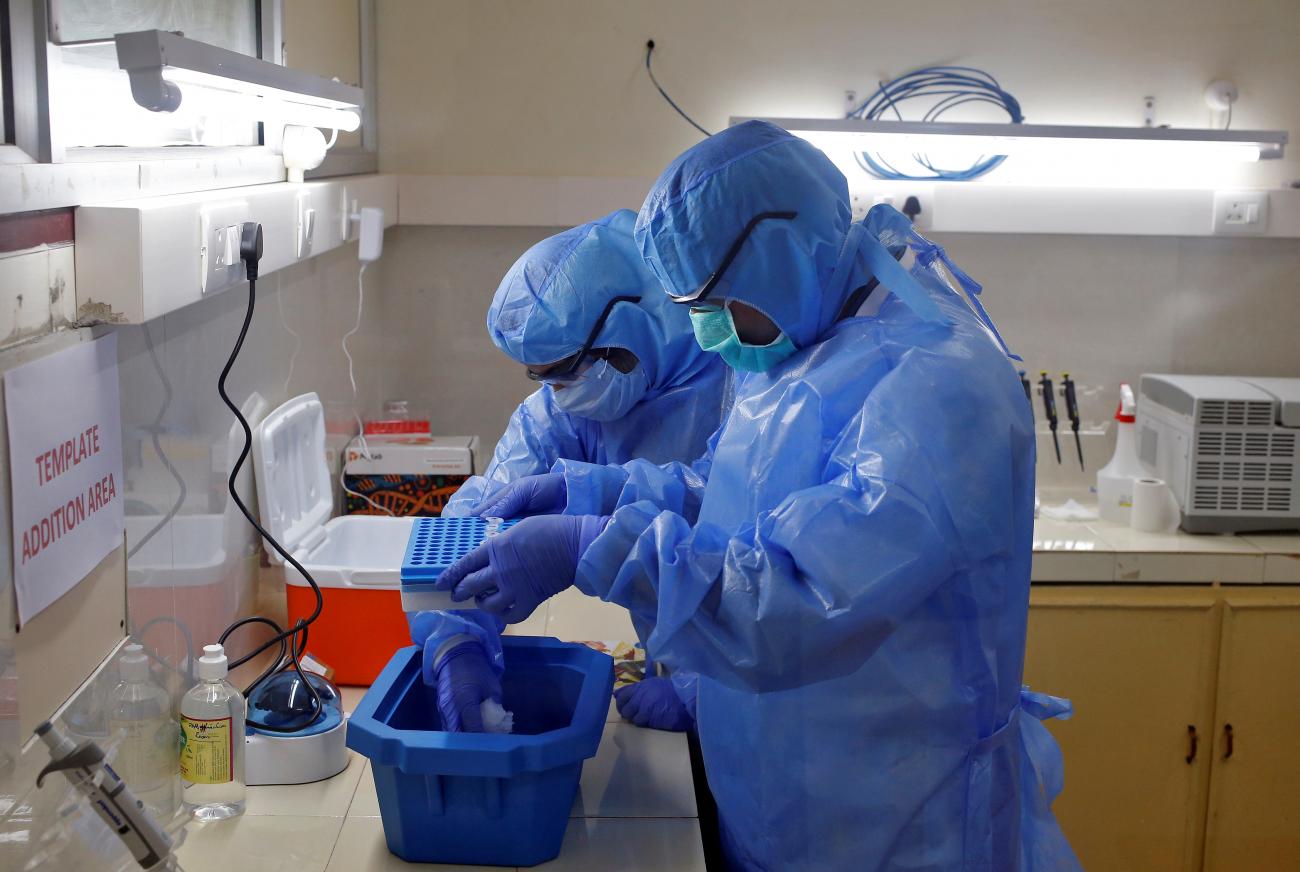 Microbiologists process COVID-19 tests in a lab at the Government Medical College in Kochi, India, on April 17, 2020.
