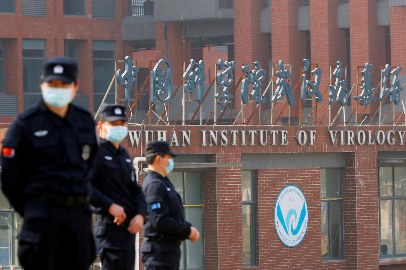 Security personnel keep watch outside Wuhan Institute of Virology during a visit by a WHO team investigating the origins of COVID, in Wuhan, Hubei province, China, on February 3, 2021. 