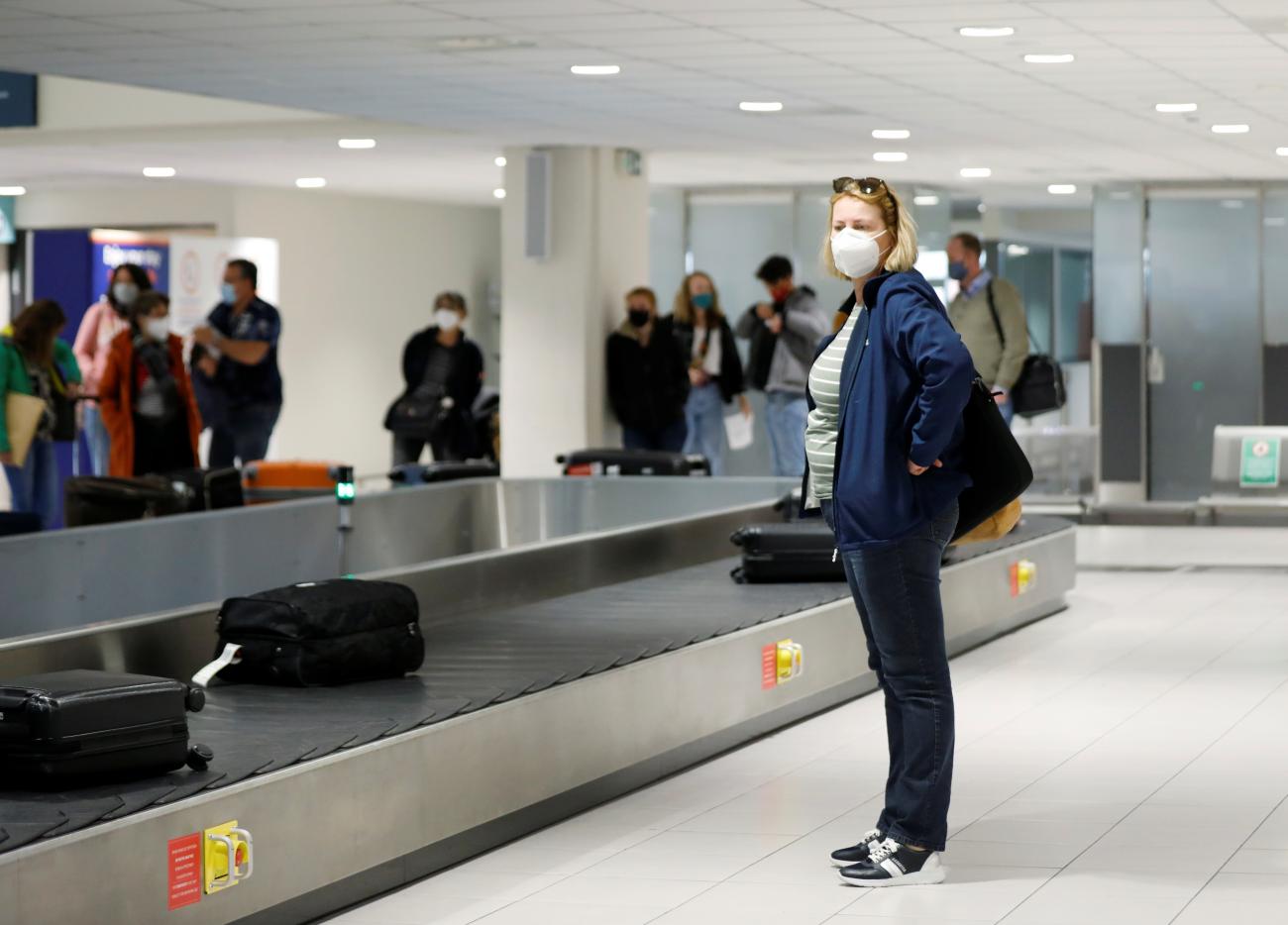 Dutch tourists, who will spend a weeklong holiday in isolation in their tourist resort as part of an experiment, arrive at the Rhodes International Airport, amid the coronavirus disease (COVID-19) outbreak on the island of Rhodes, Greece April 12, 2021.