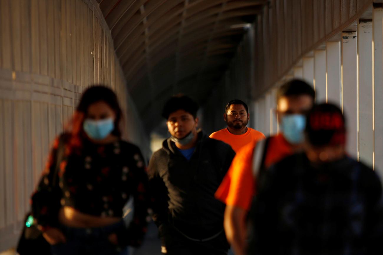 People walk toward the United States at the Paso del Norte International Border bridge after the U.S. Department of Homeland Security announced the upcoming November reopening of its border through land ports of entry for people inoculated against COVID-19, with vaccines authorized by the World Health Organization, in Ciudad Juarez, Mexico, on October 13, 2021.