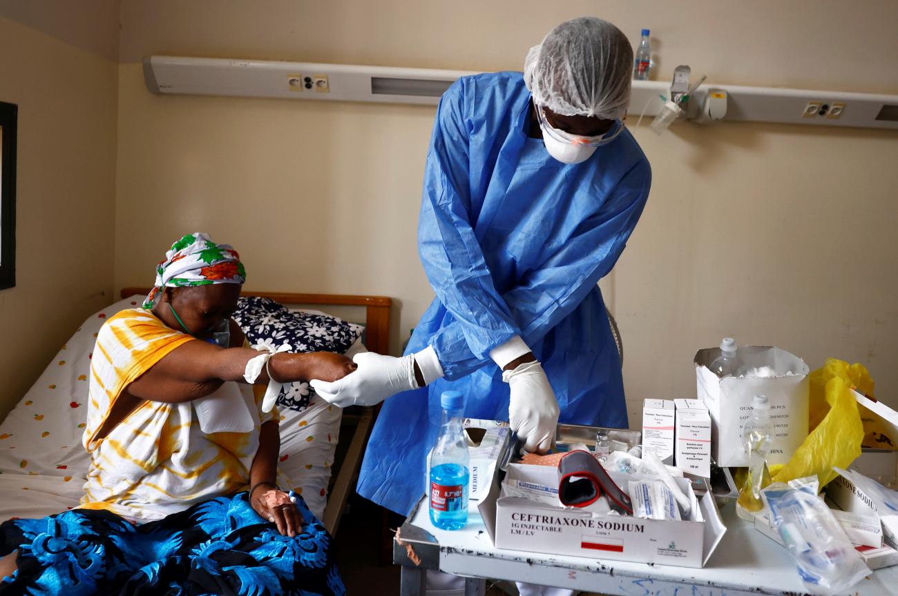 Nurse Ibrahima Toumane cares for a COVID patient at Dalal Jamm Hospital in Dakar, Senegal, on August 5, 2021, during a peak in cases.