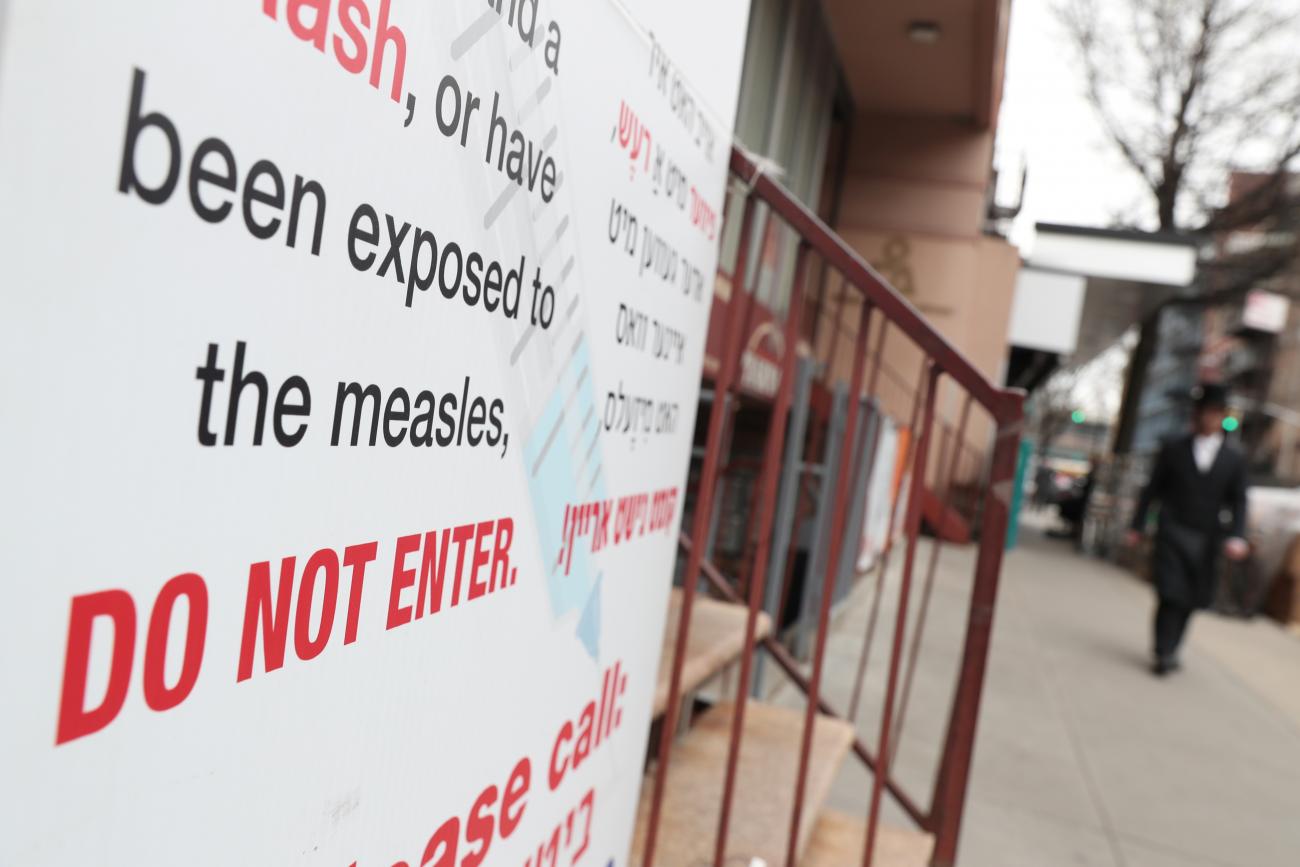 A sign warning people of measles two days after New York City Mayor Bill de Blasio declared a public health emergency in parts of Brooklyn in response to a measles outbreak, in New York, on April 11, 2019. 