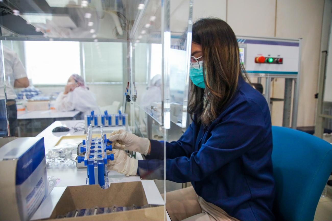 A technician works an AutoVacc machine designed by the Chulalongkorn University's Biomedical Engineering Research Center to extract extra doses out of AstraZeneca vaccine vials in Bangkok, Thailand.