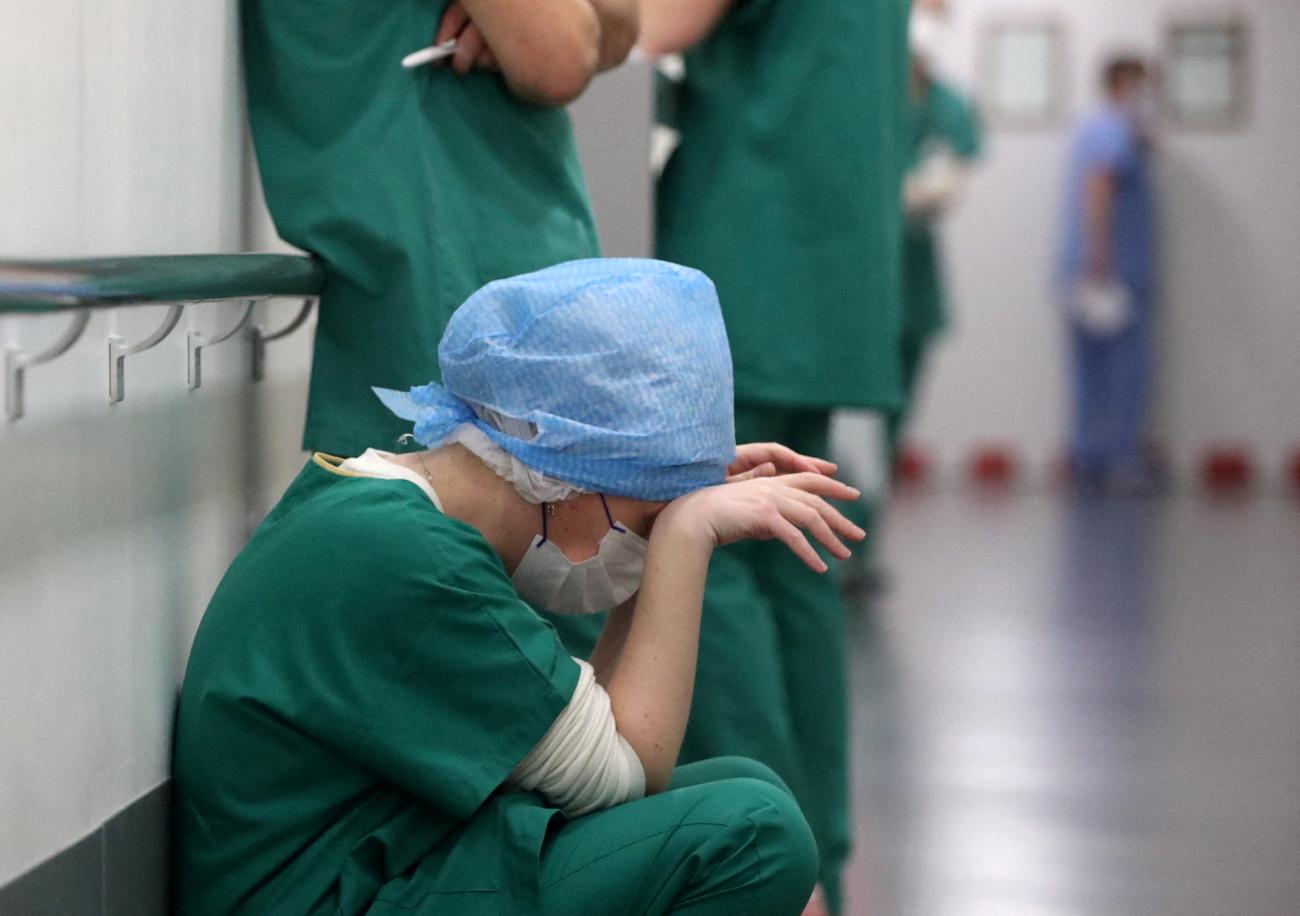 Doctor Ruxandra Divan, rests in the Intensive Care Unit for COVID-19 patients at Hopitaux Civils de Colmar in Colmar, France, on December 15, 2021. REUTERS/Yves Herman