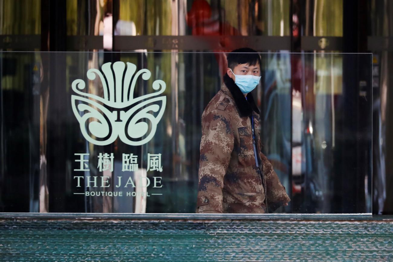 A security guard keeps watch outside the hotel where members of the World Health Organisation (WHO) team, tasked with investigating the origins of the coronavirus (COVID-19) pandemic, are quarantined in Wuhan, Hubei province, China, January 15, 2021.