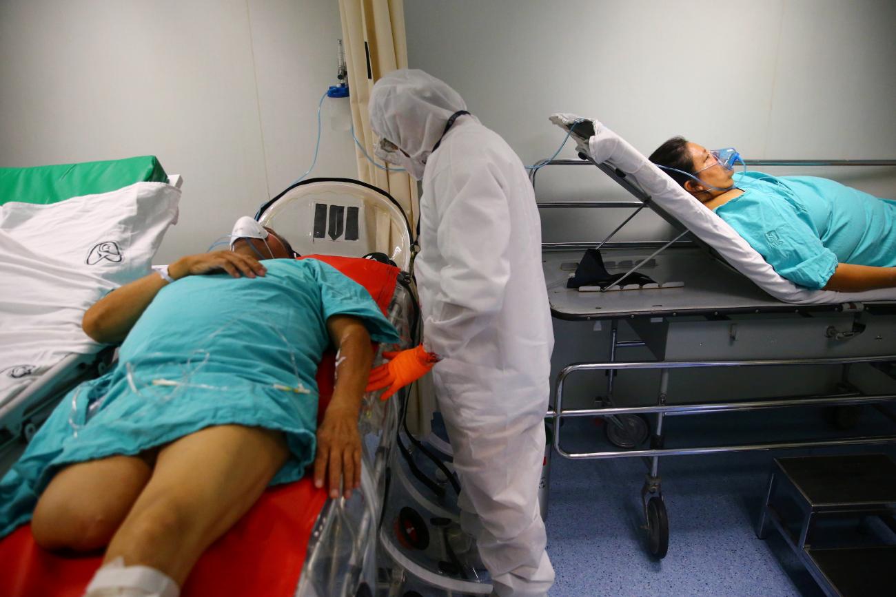 A patient suffering from COVID-19 and diabetes, is pictured on a capsule as Red Cross paramedics prepare to transfer him from a hospital to another in Mexico City, Mexico, on June 8, 2020.