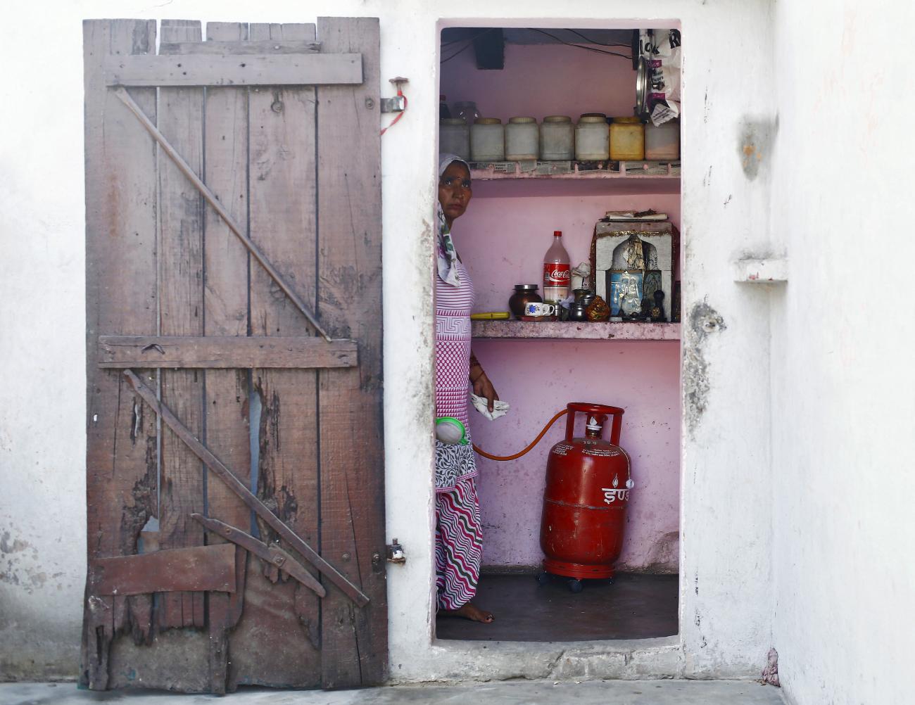  A housewife cooks in her kitchen at Dujana village in Noida, near New Delhi, India, on October 7, 2015. 