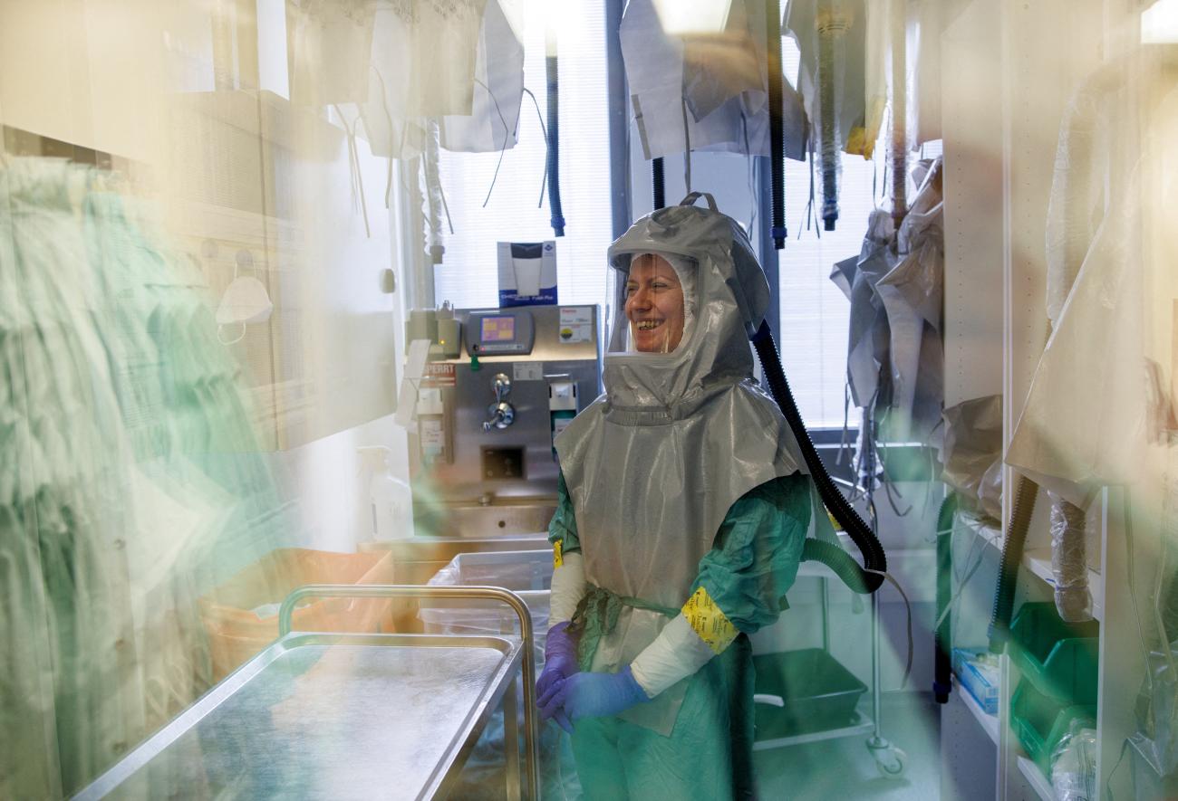 A biologist at the French-Austrian biotech firm Valneva laughs as she waits in a double door system before entering a laboratory to work on an inactivated whole-virus vaccine against coronavirus disease (COVID-19) in Vienna, Austria, December 16, 2021.