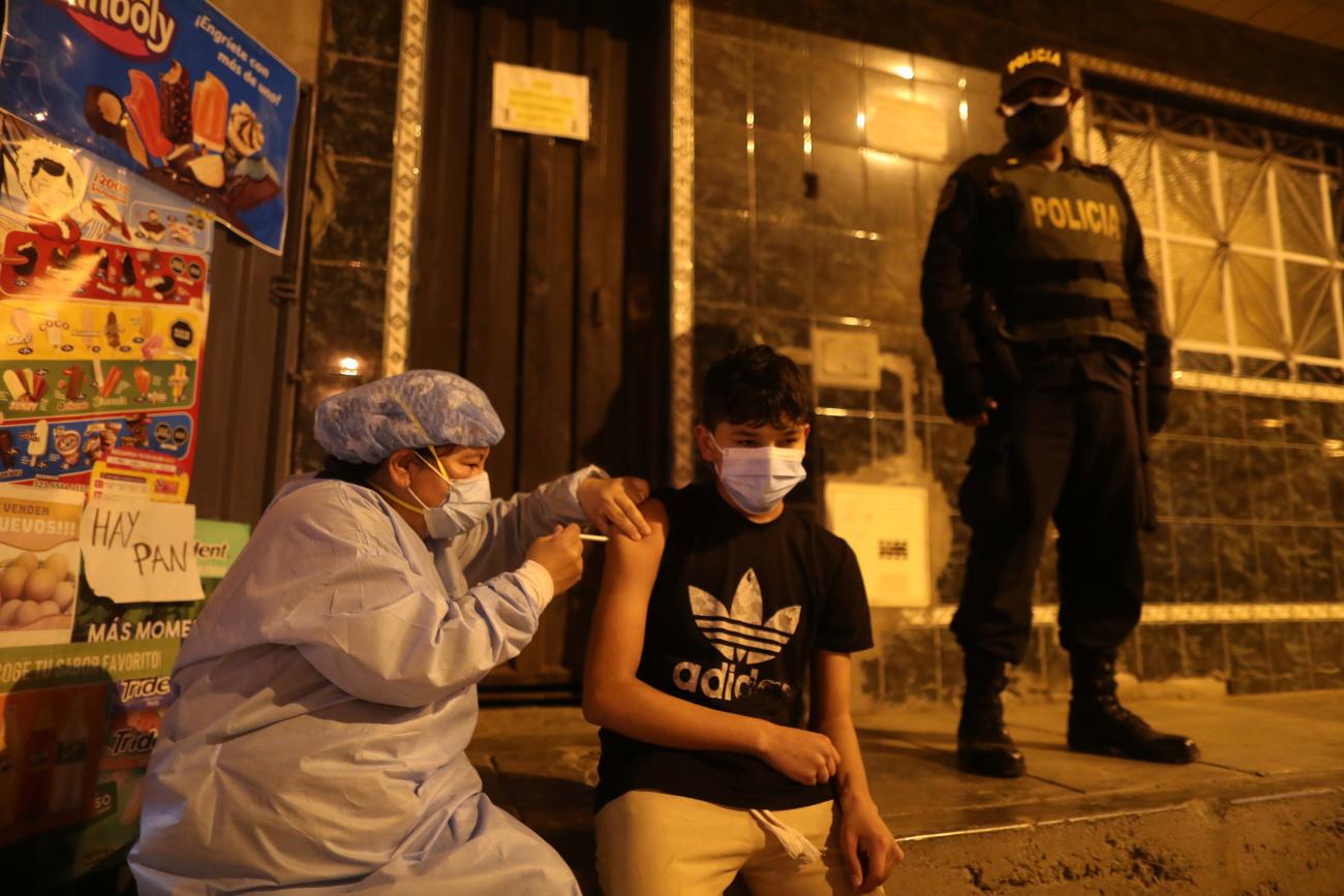 A health-care worker administers a dose of the Pfizer-BioNTech COVID-19 vaccine during an initiative to vaccinate people over 12 years old, in Lima, Peru, on December 6, 2021.
