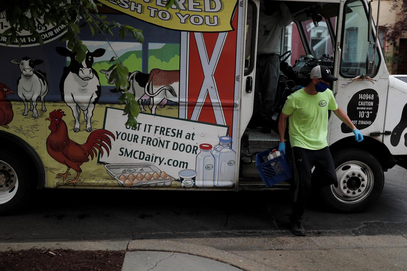 Anxiety over in-store shopping rose during the pandemic, creating a surge of interest in online ordering and home grocery delivery. In the photo, a man delivers milk in Washington, DC, on May 18, 2020.