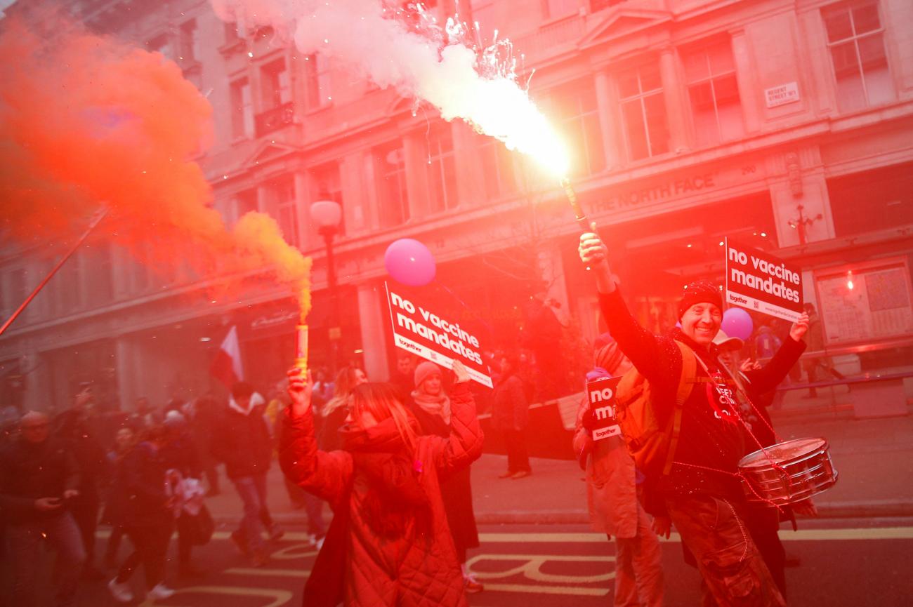 People burn flares as National Health System staff protest against COVID-19 vaccine rules, in London, England, on January 22, 2022.