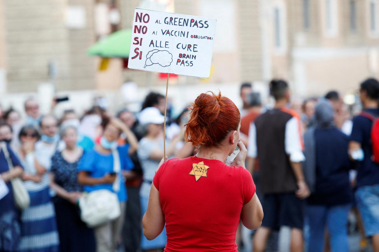 A  protester demonstrating against the Green Pass plan (health pass)wears a Second World War emblem depicting the star of David badge with a German word "Jude" (Jew), as a health pass certificate has become mandatory to access an array of services and leisure activities, in Rome, Italy, on August 14, 2021.
