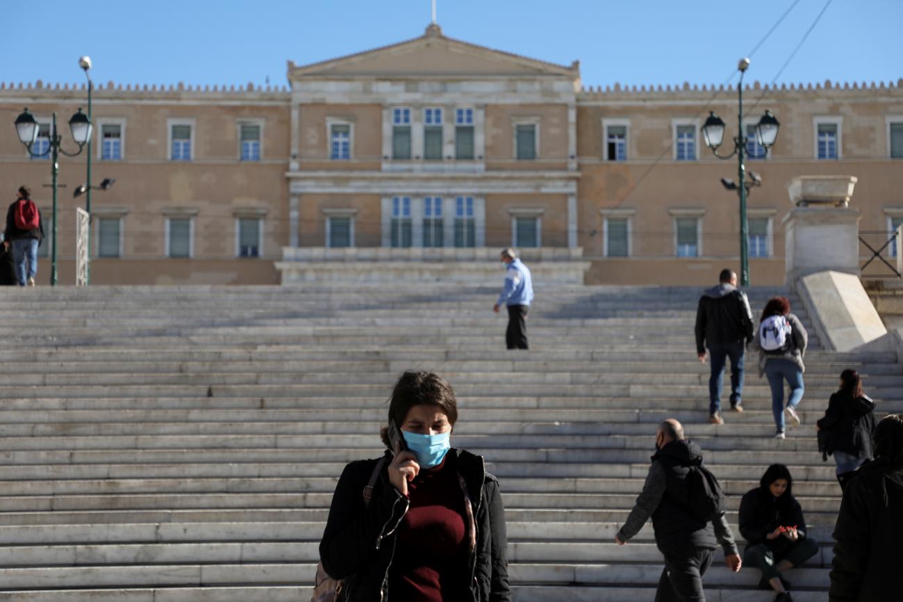 People wearing protective face masks make their way on Syntagma square, in Athens, Greece, on December 1, 2021.