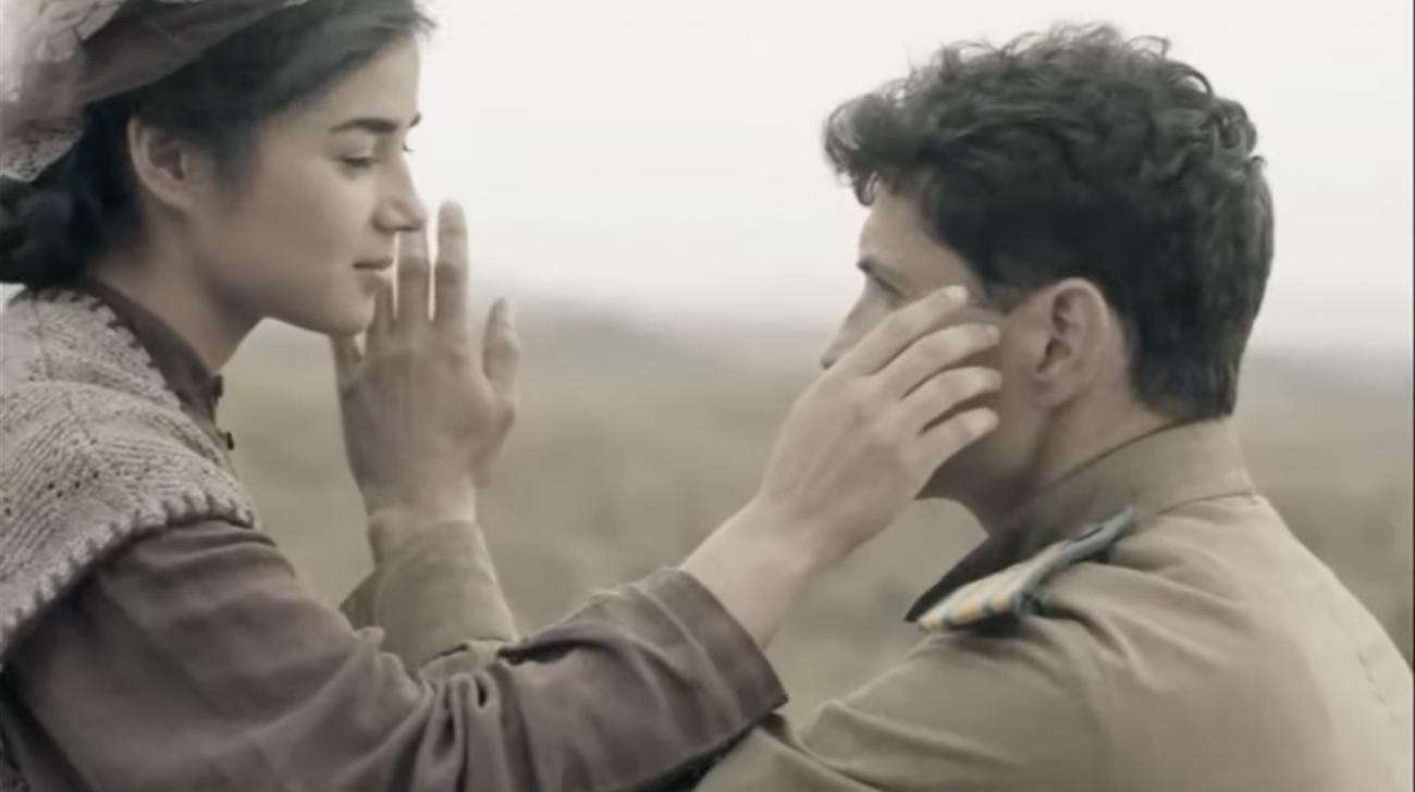 A Tatar man and woman touch each other's faces as they dance