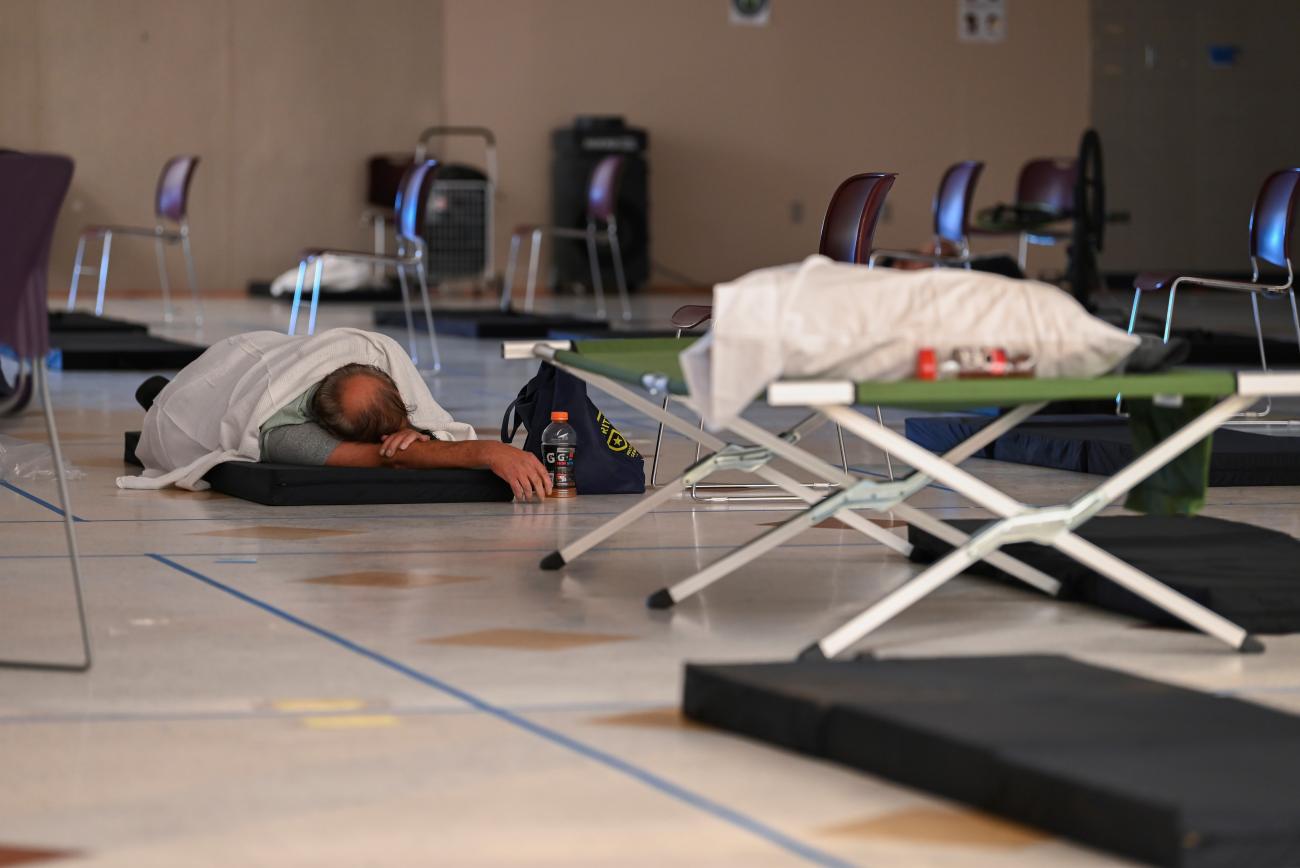 A man rests on a cot inside a cooling shelter during a heatwave in Portland, Oregon, on August 11, 2021. 