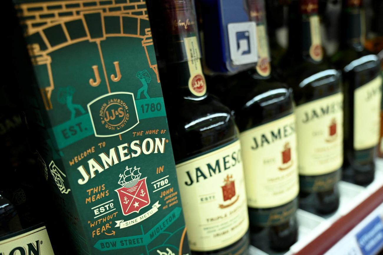 A close-up image shows bottles of Jameson whiskey with green labels, lined up on a supermarket shelf in Galway, Ireland, on January 4, 2022. 
