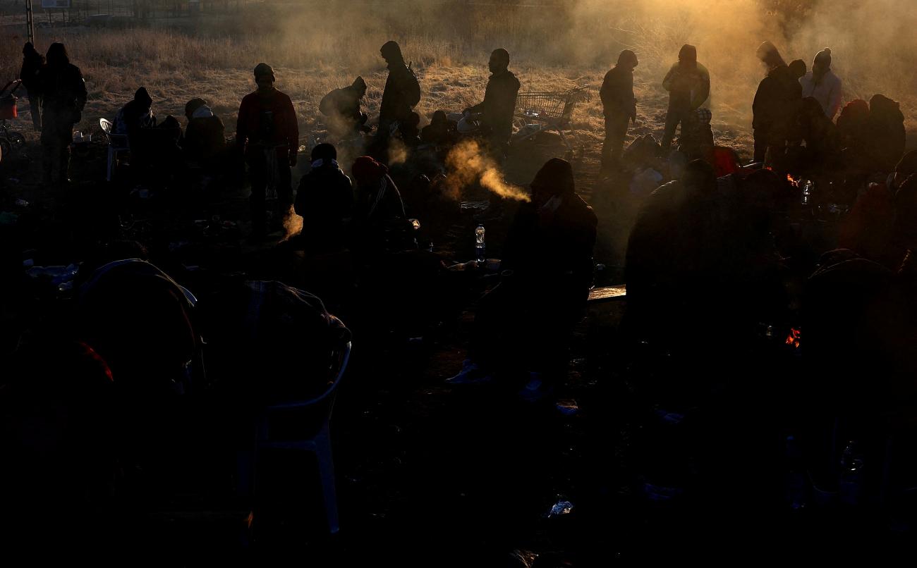 Refugees brave the cold in a frozen field after they fled from Ukraine because of the Russian invasion at the border checkpoint in Medyka, Poland, March 1, 2022.