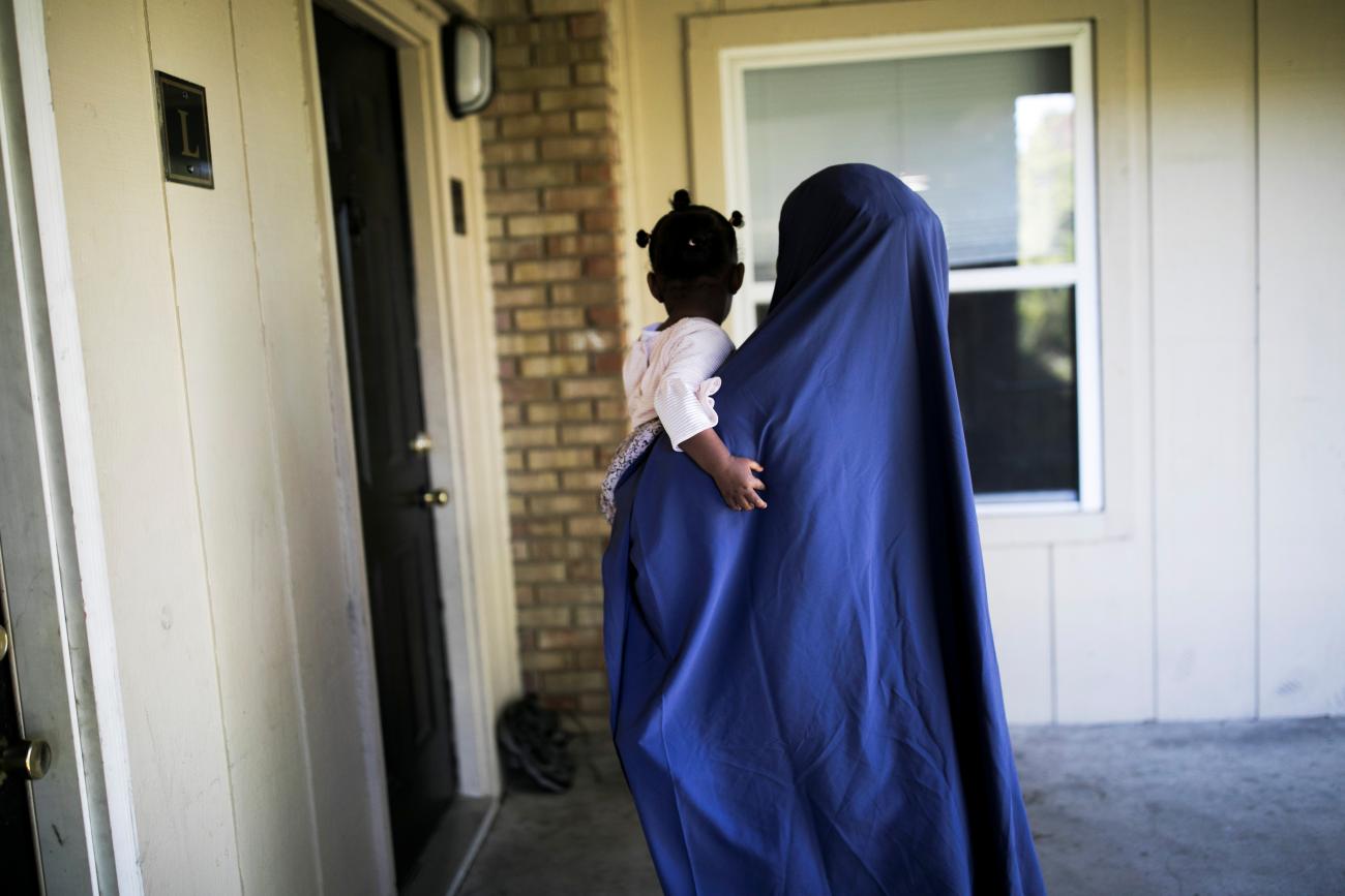 A woman walks into her apartment with her daughter in Columbus, Ohio, on September 27, 2019.