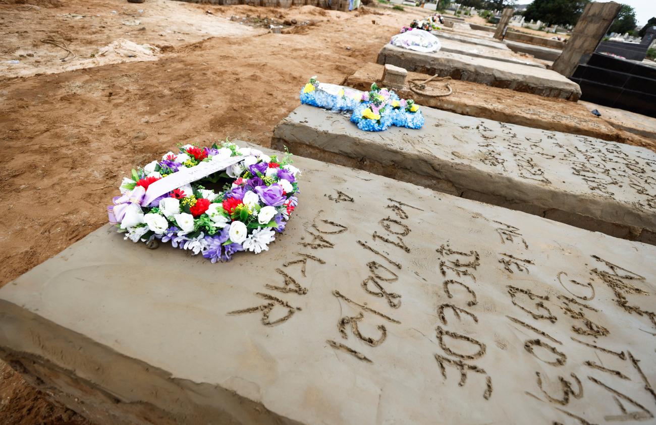 A wreath of flowers lies atop the grave of a man who, according to his son, died from COVID-19 at the Christian Saint-Lazare Cemetery in Dakar, Senegal, on August 4, 2021.