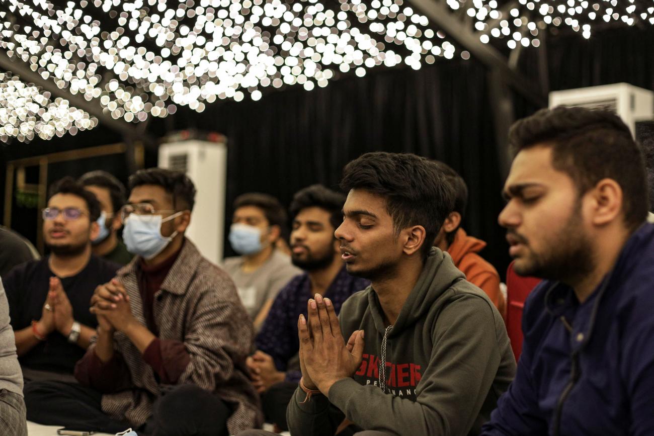 After fleeing Ukraine, Indian students pray for peace for Ukrainian people under twinkle lights at a wedding venue where they are sheltering in Corbeanca, Romania, March 1, 2022. 