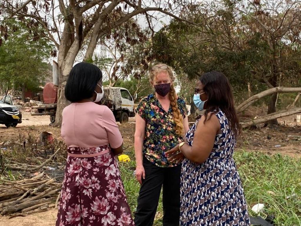 The author (center) and her colleagues look at potential transmission risk factors near the Weija dam on a field visit in Weija, Ghana.