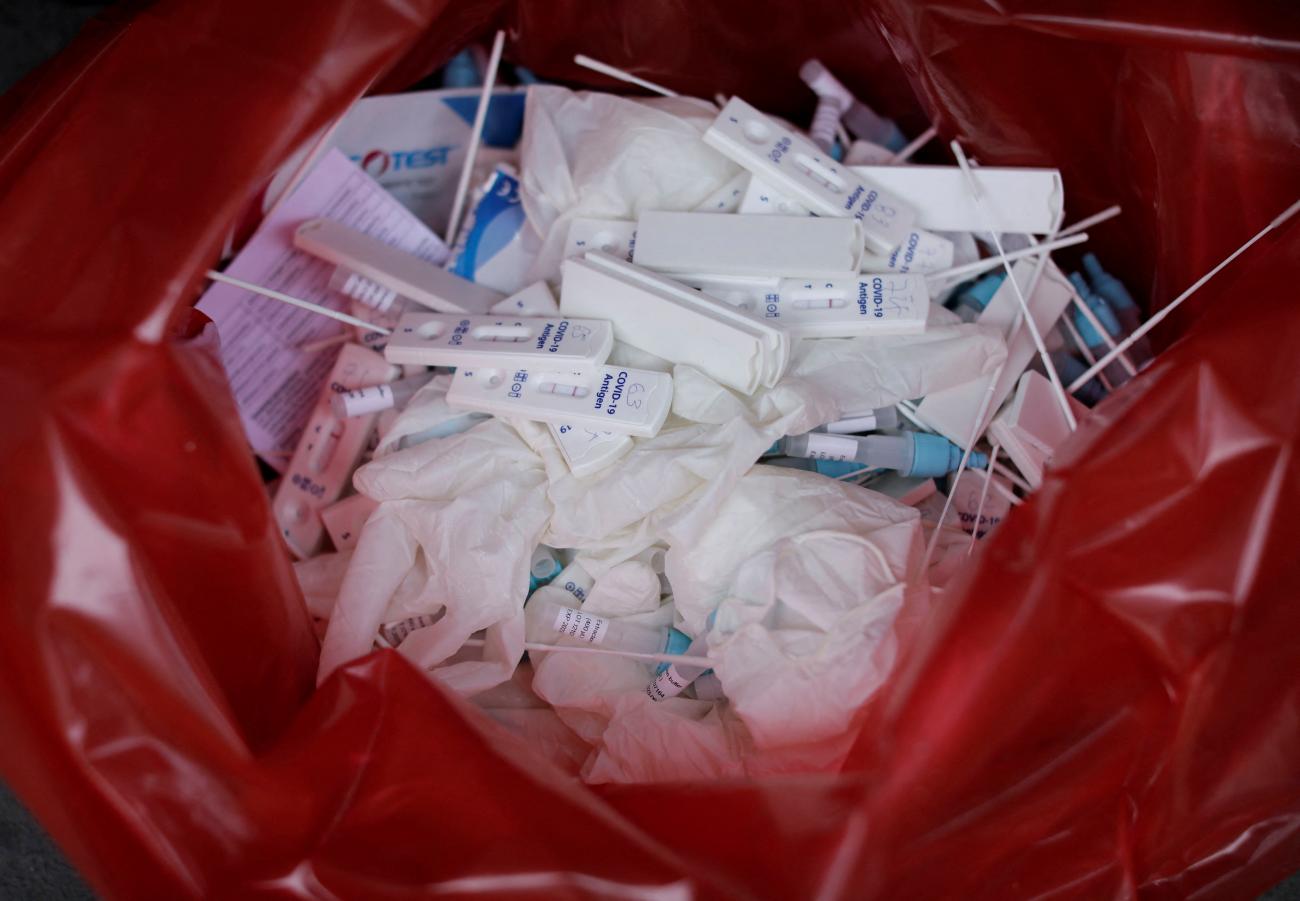Processed and discarded Antigen tests and testing material for COVID-19 are seen in a red medical waste bag in Lima, Peru, January 6, 2022. 
