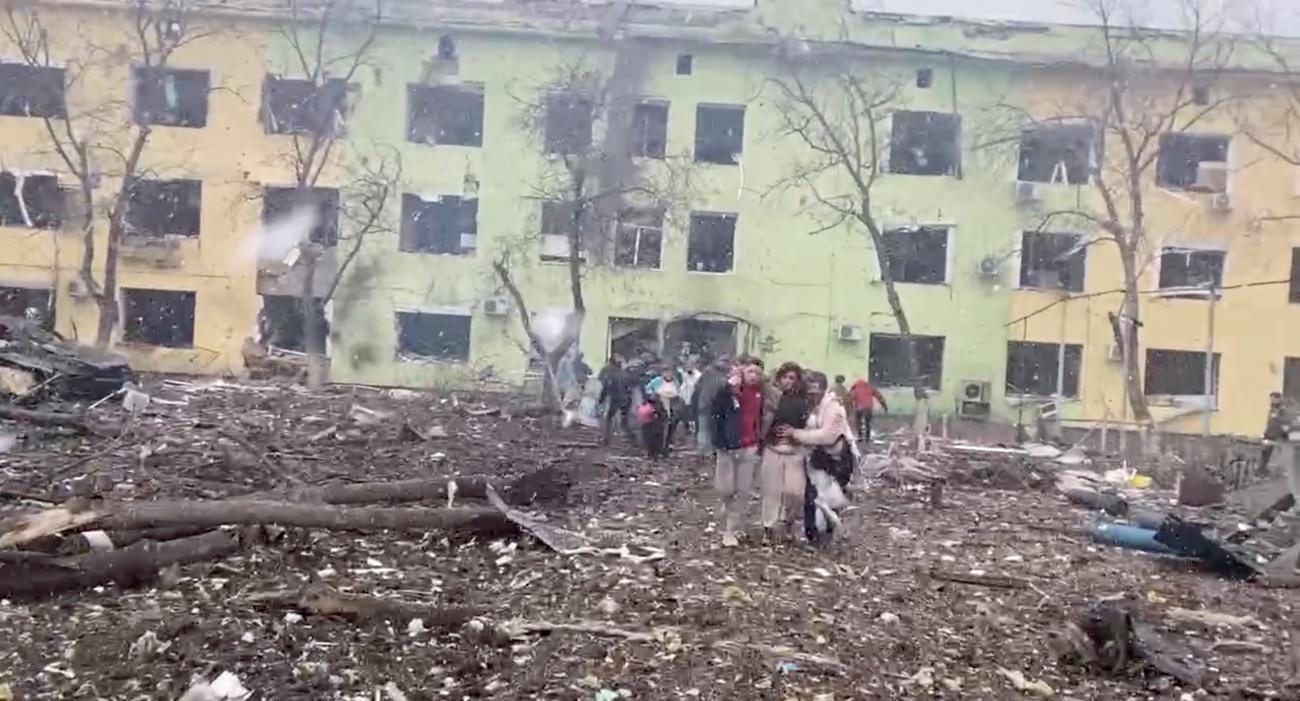 People emerge from a children's hospital that was bombed by Russian forces in Mariupol, Ukraine, March 9, 2022 