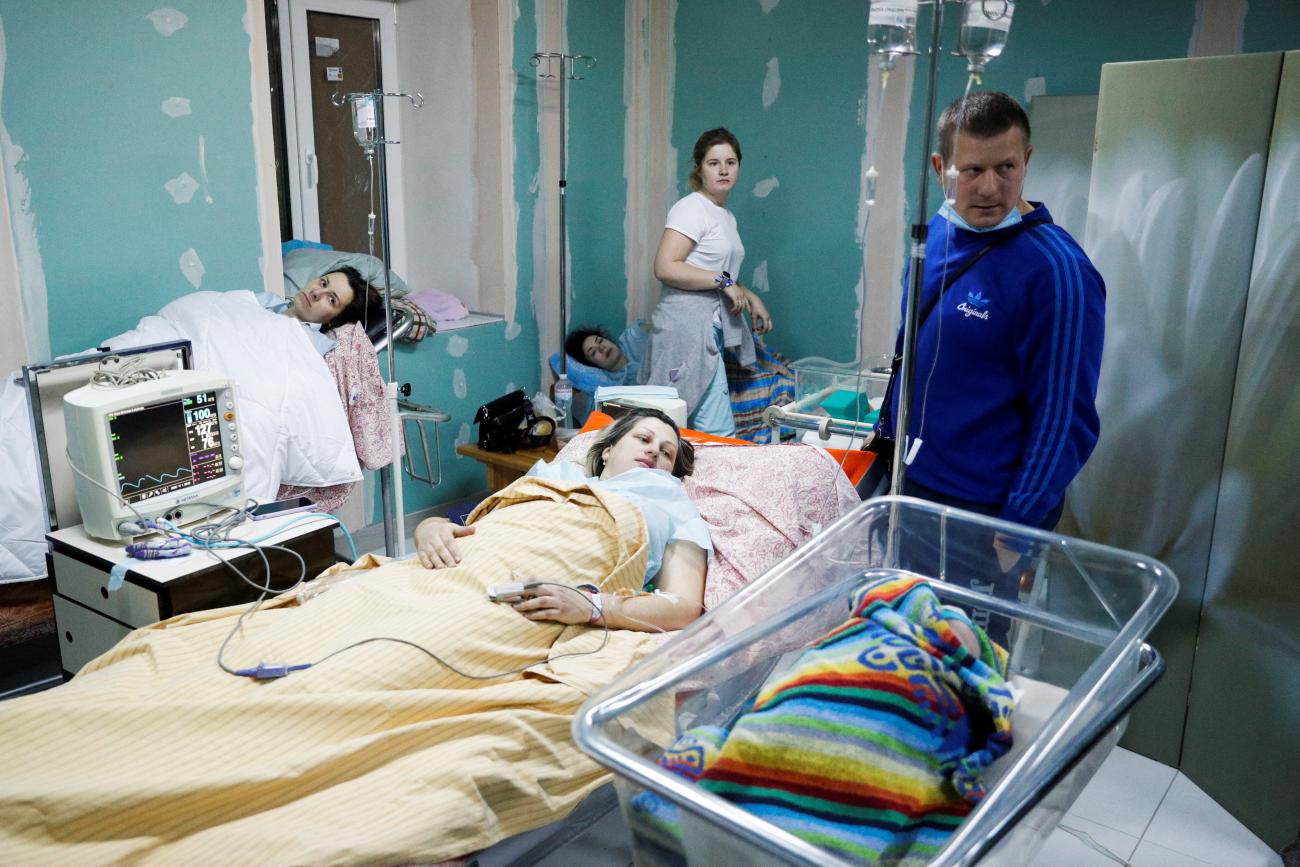 Expecting mothers and the parents of a new born baby shelter in a basement of a maternity hospital as air raid siren sounds are heard in Kyiv, Ukraine