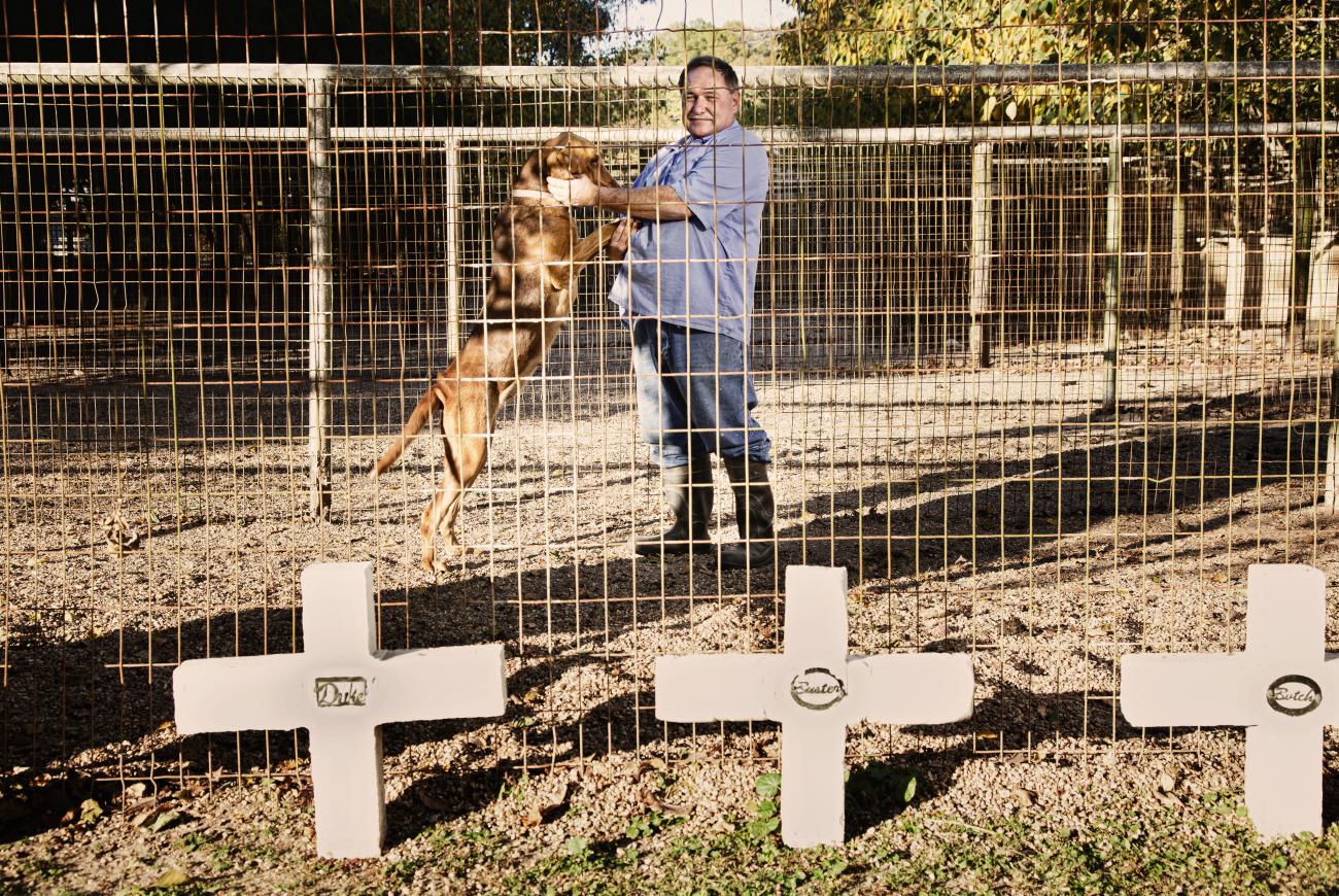 The dog trainer was at Angola. He had trained dozens of animals while there. The three crosses were out of about twenty dogs that died since he was working at the prison.