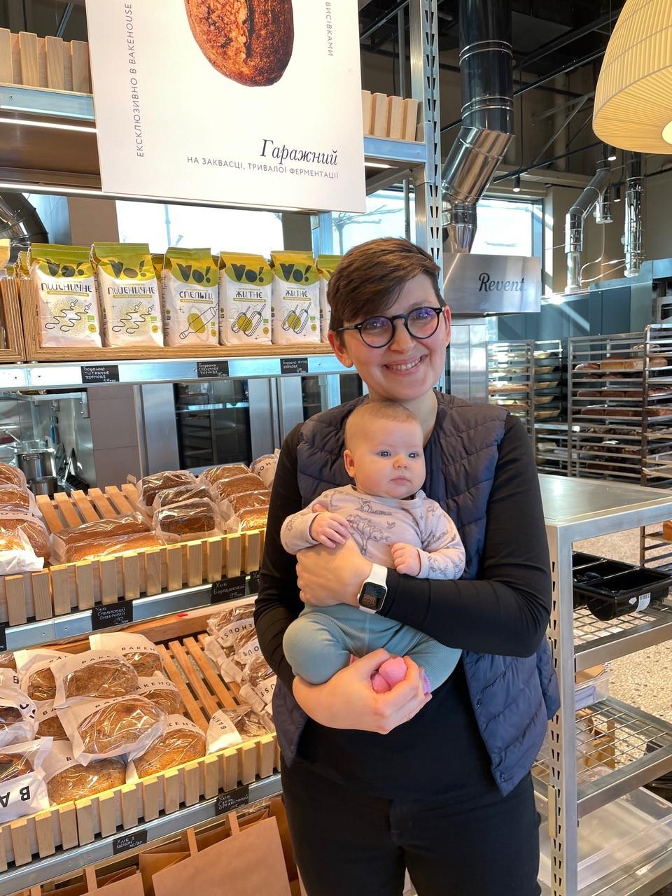 Anna Makievska and her infant daughter stand in front of rows of pastries in Bakehouse two days before the invasion, Kyiv, Ukraine, February 22, 2022