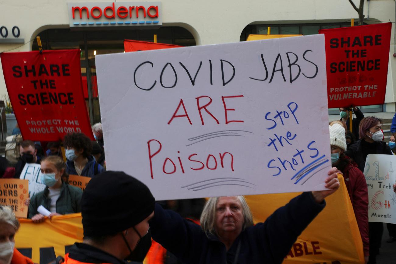 An anti-vaccine counter-protestor stands in a demonstration calling for Moderna to freely share the technology behind their coronavirus disease (COVID-19) vaccine with the rest of the world outside the company's headquarters in Cambridge, Massachusetts, U.S., April 28, 2022.