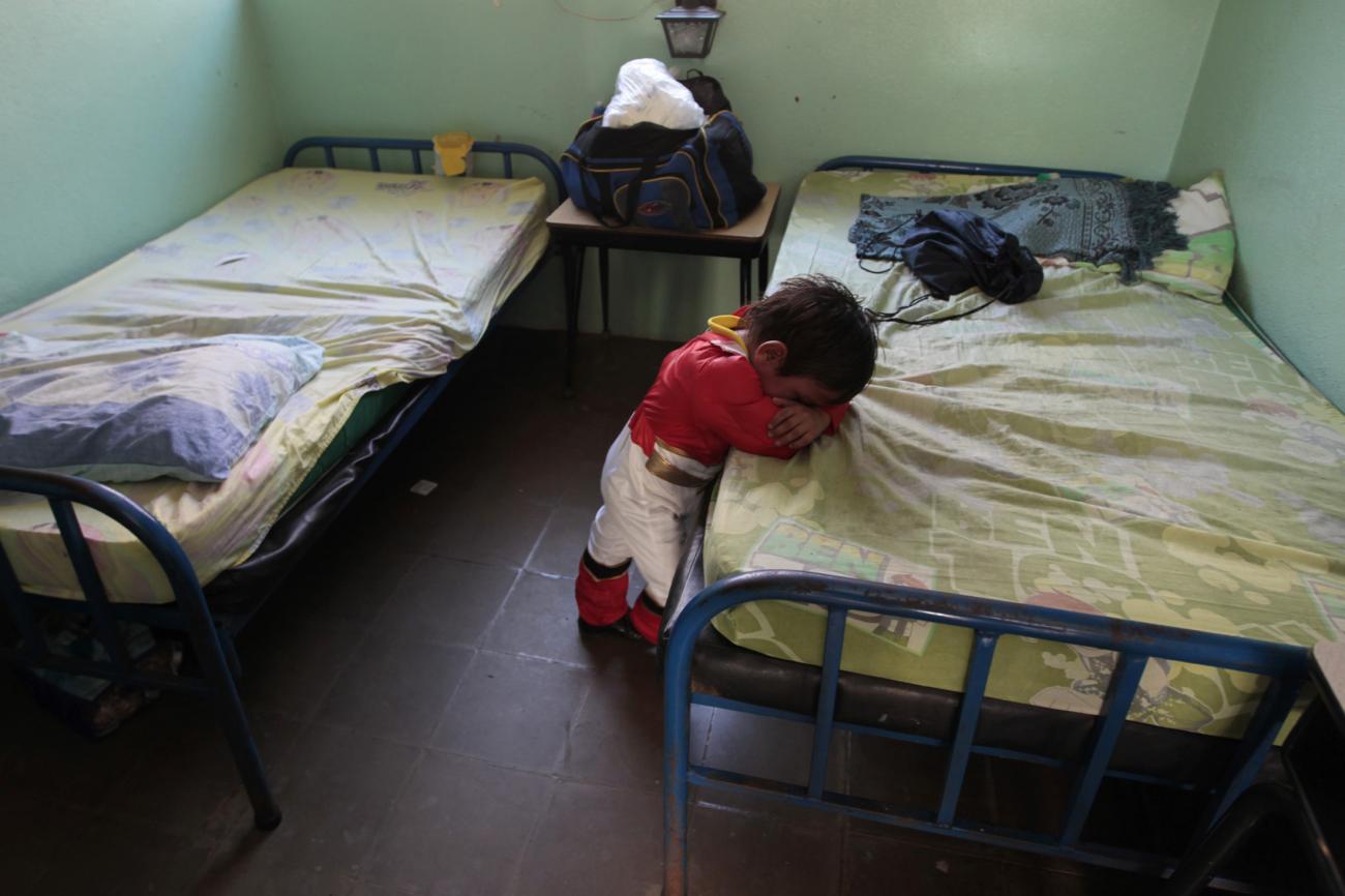 A child cancer patient dressed as a power ranger takes a break after a march to observe the International day of the fight against childhood cancer in Managua, Nicaragua, on February 14, 2015.