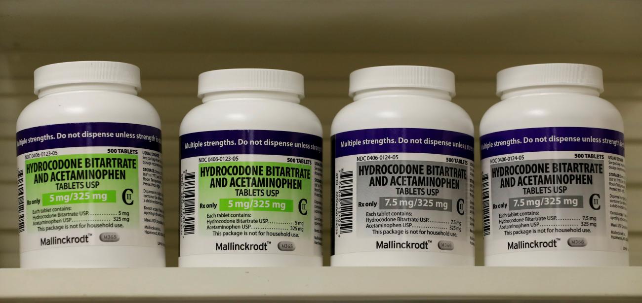 Bottles of prescription painkillers, hydrocodone bitartrate and acetaminophen, sit on a shelf at a local pharmacy in Provo, Utah, on April 25, 2017.