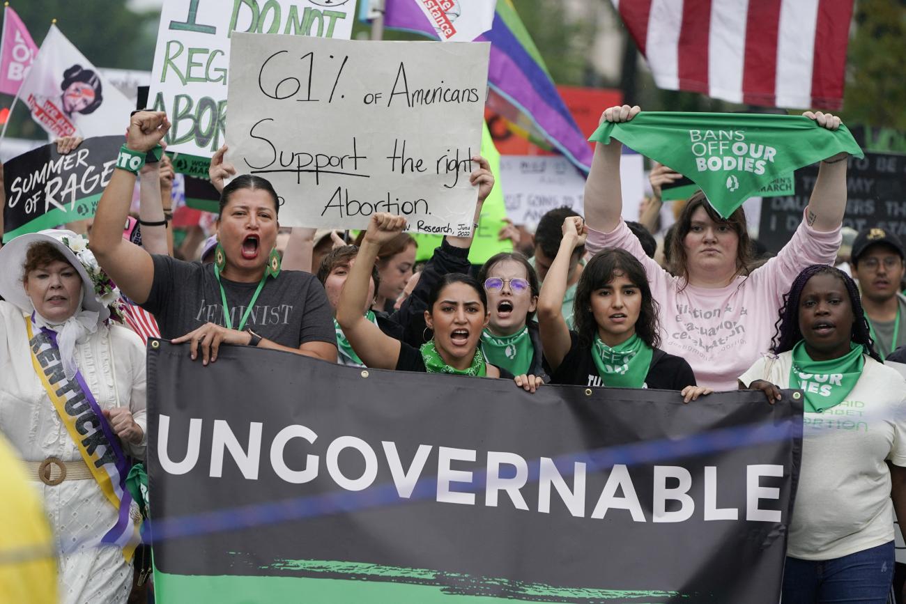 Women holding a black banner reading "ungovernable" protest the recent U.S. supreme court's decision to overturn Roe v. Wade