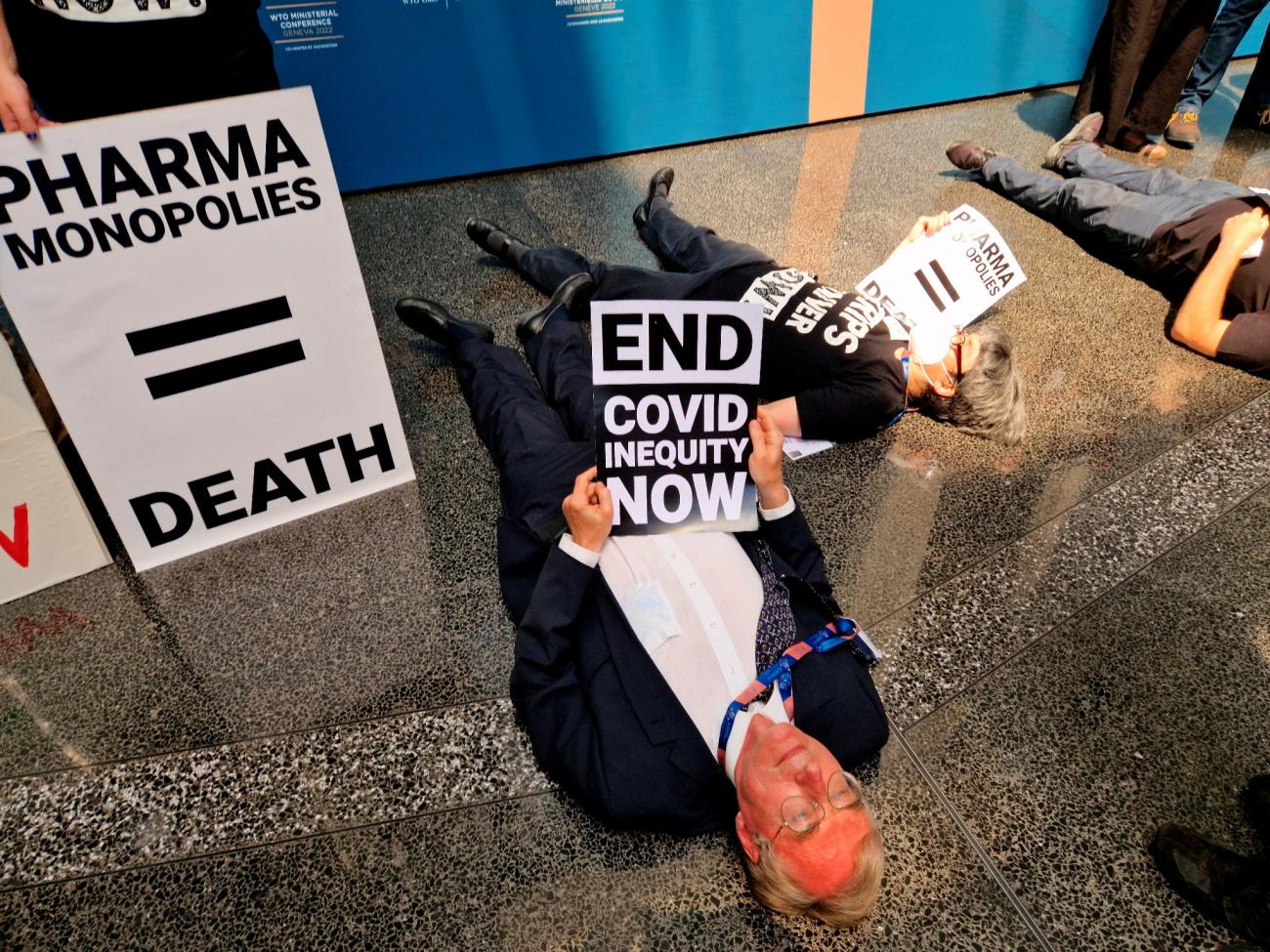 Civil society groups perform "die-in" protest over WTO negotiations on compromise that they say does not go far enough in allowing developing countries to produce COVID-19 vaccines.