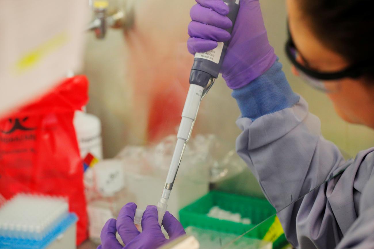 Technicians separate specimens from COVID-19 tests to be processed for a positive or negative result at the UW Medicine Virology lab in Seattle, Washington, on March 18, 2020