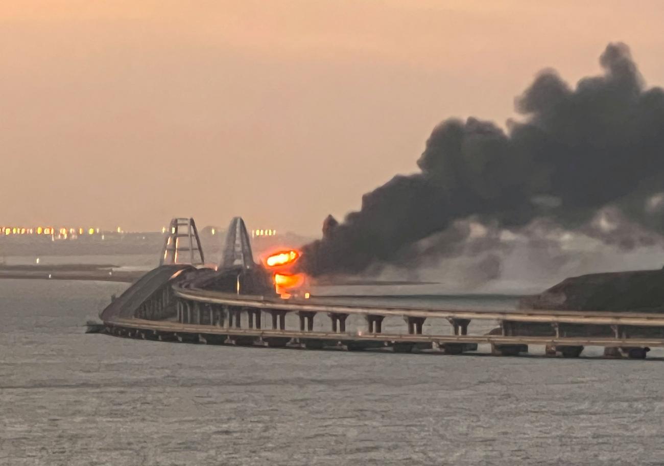 A view shows a fire on the Kerch bridge at sunrise in the Kerch Strait, Crimea, October 8, 2022. 
