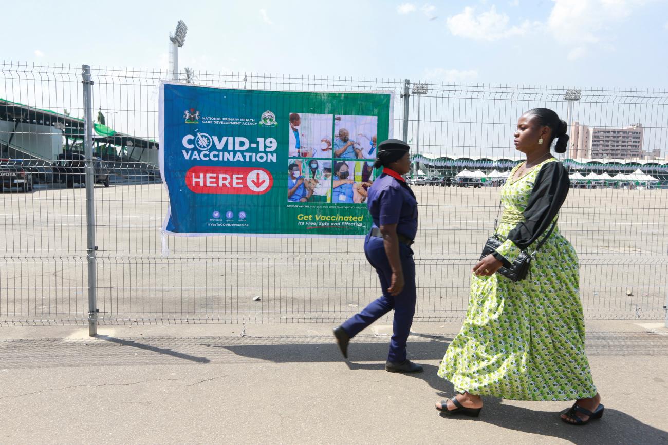 Two women walk past a vaccination centre after the government commenced the roll out of mass vaccination for coronavirus disease (COVID19) in Abuja, Nigeria, November 19, 2021.