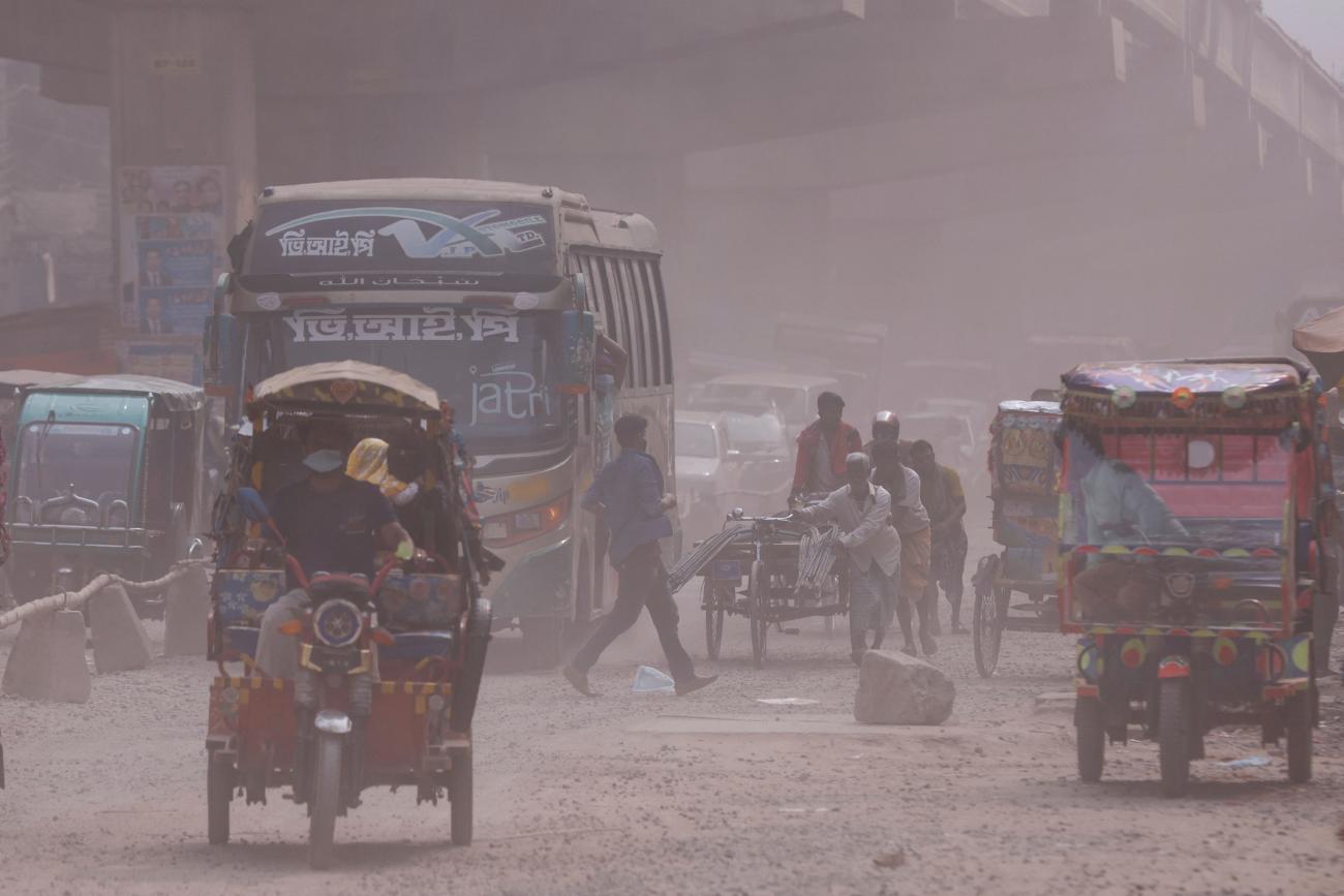 Vehicles are moving on a dusty road as air pollution worsens during winters in Tongi area of Gazipur, Bangladesh, February 3, 2022. 