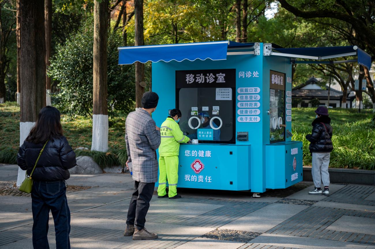 People line up at a mobile fever clinic that was transformed from a nucleic acid testing booth for COVID-19 in Zhejiang province, China December 22, 2022. 