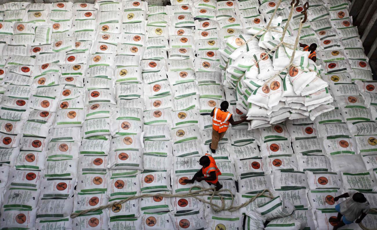 Rows of white bags holding rice are lined up at a Kenyan port, where workers load relief food onto a Somalia-bound ship in Mombasa, Kenya, on October 10, 2011. 