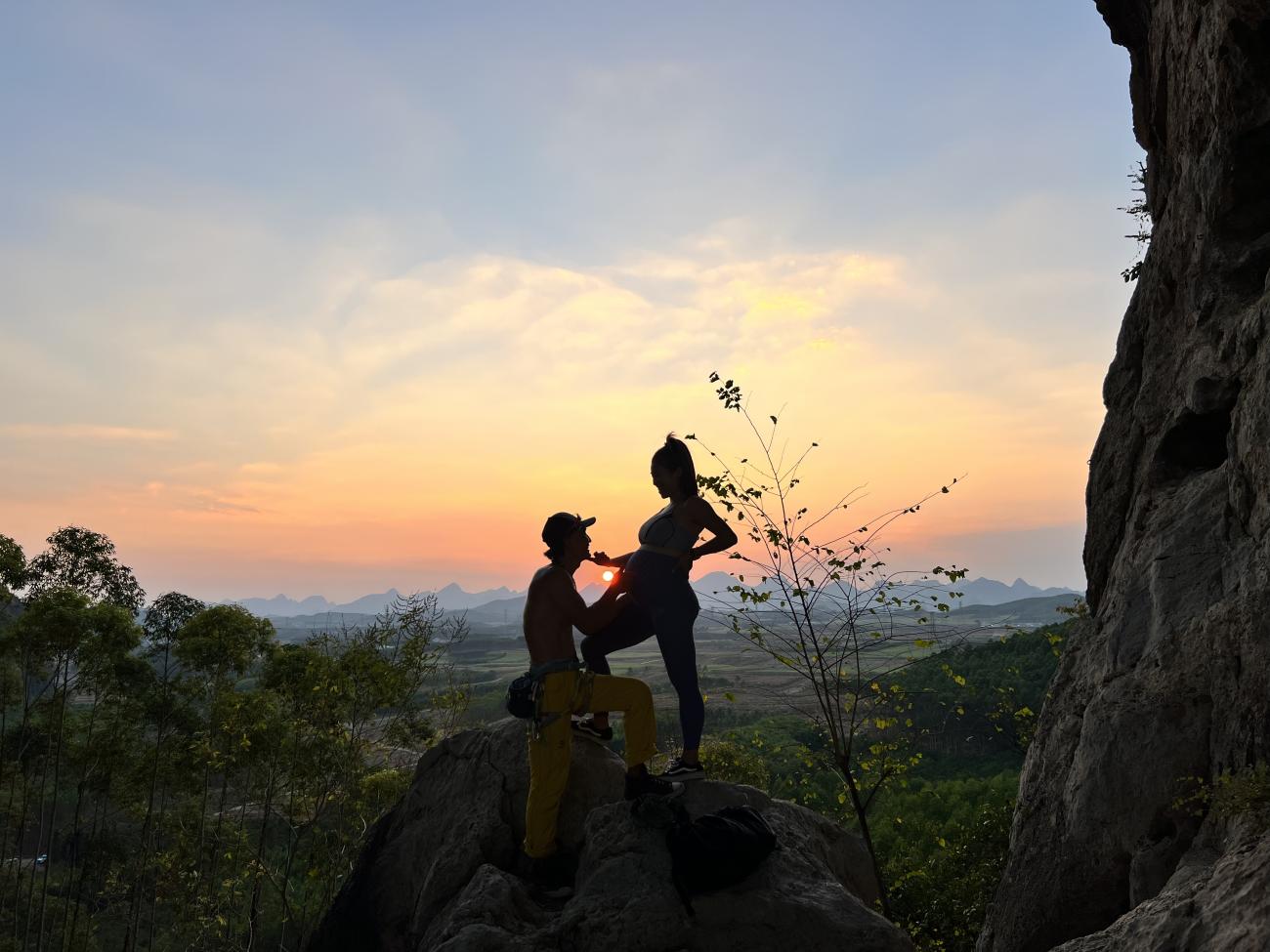 Min and her husband pose for a maternity shoot in a climbing area in Yangshuo, China during sunset, 2022.