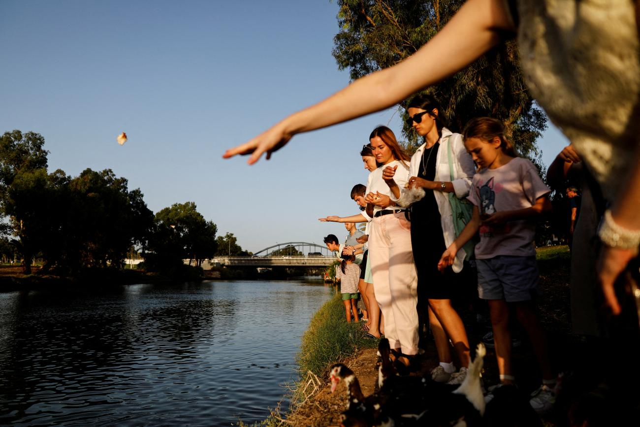 Jewish people perform a Tashlich ceremony, whereby they symbolically cast away their sins, on a Rosh Hashanah, by the Yarkon river in Tel Aviv, Israel, on September 26, 2022.