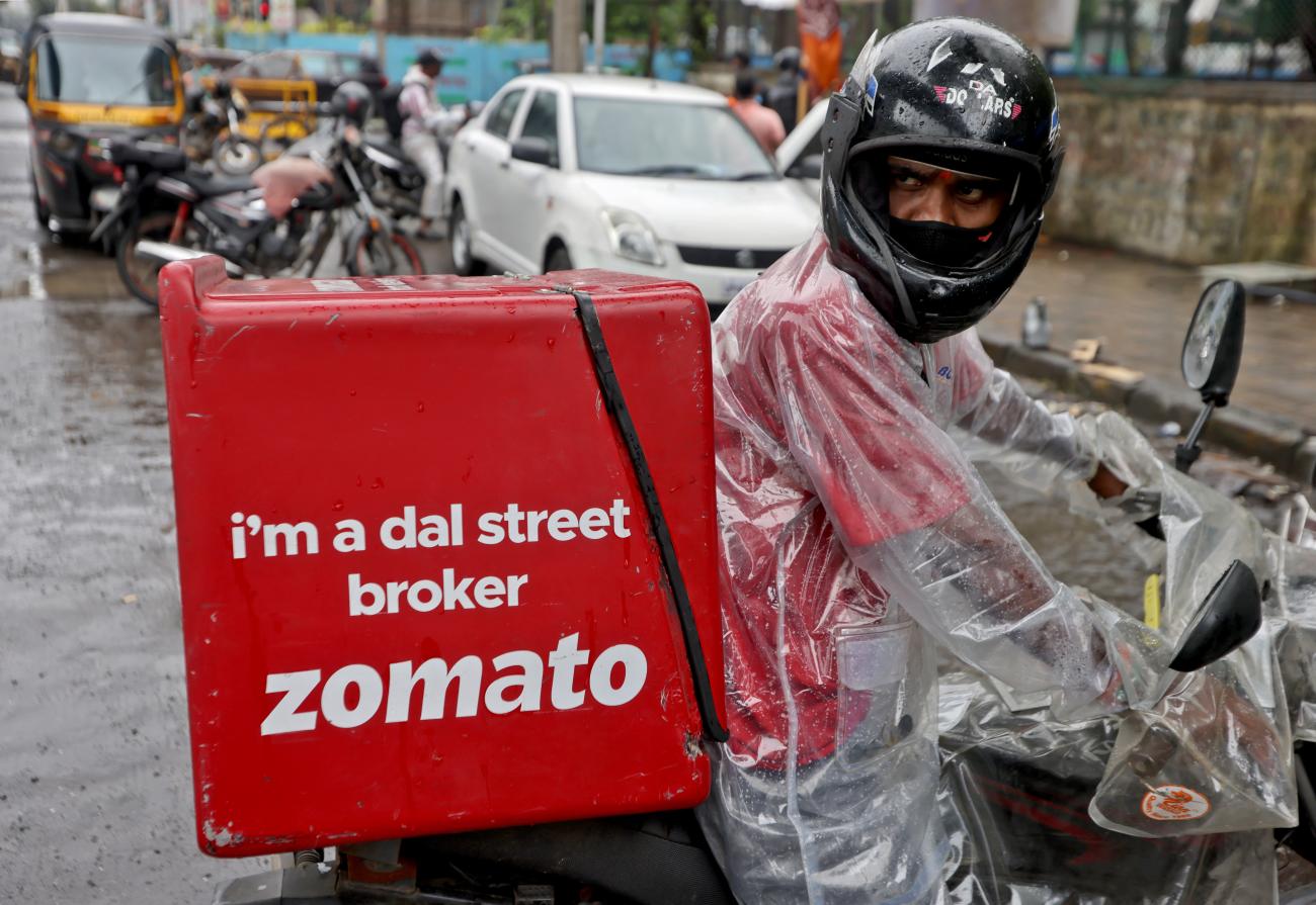 A delivery worker of Zomato, an Indian food-delivery startup, prepares to leave to pick up an order from a restaurant in Mumbai, India, July 13, 2021.