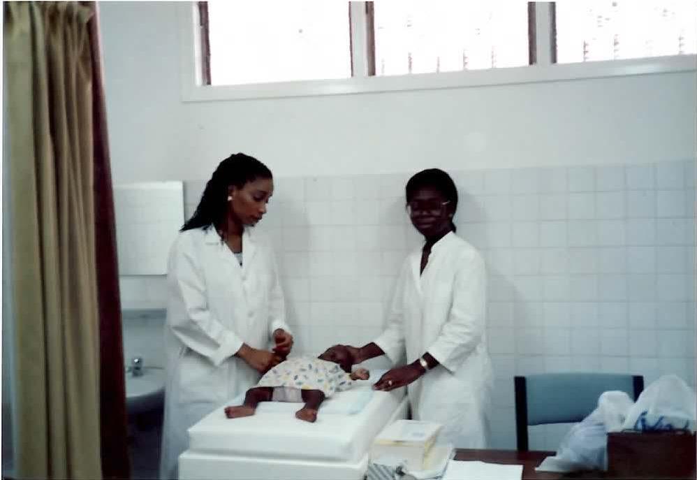 Dr, Helene Gayle and a colleague are seen tending to an infant, at a hospital in Abidjan, Cote d’Ivoire, in 1990. 