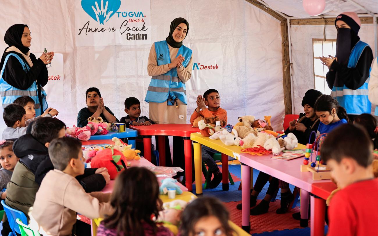 Volunteers sing with children at a camp for survivors during an activity to support the mental health of children affected by the deadly earthquake in Adiyaman, Turkey, on February 18, 2023.