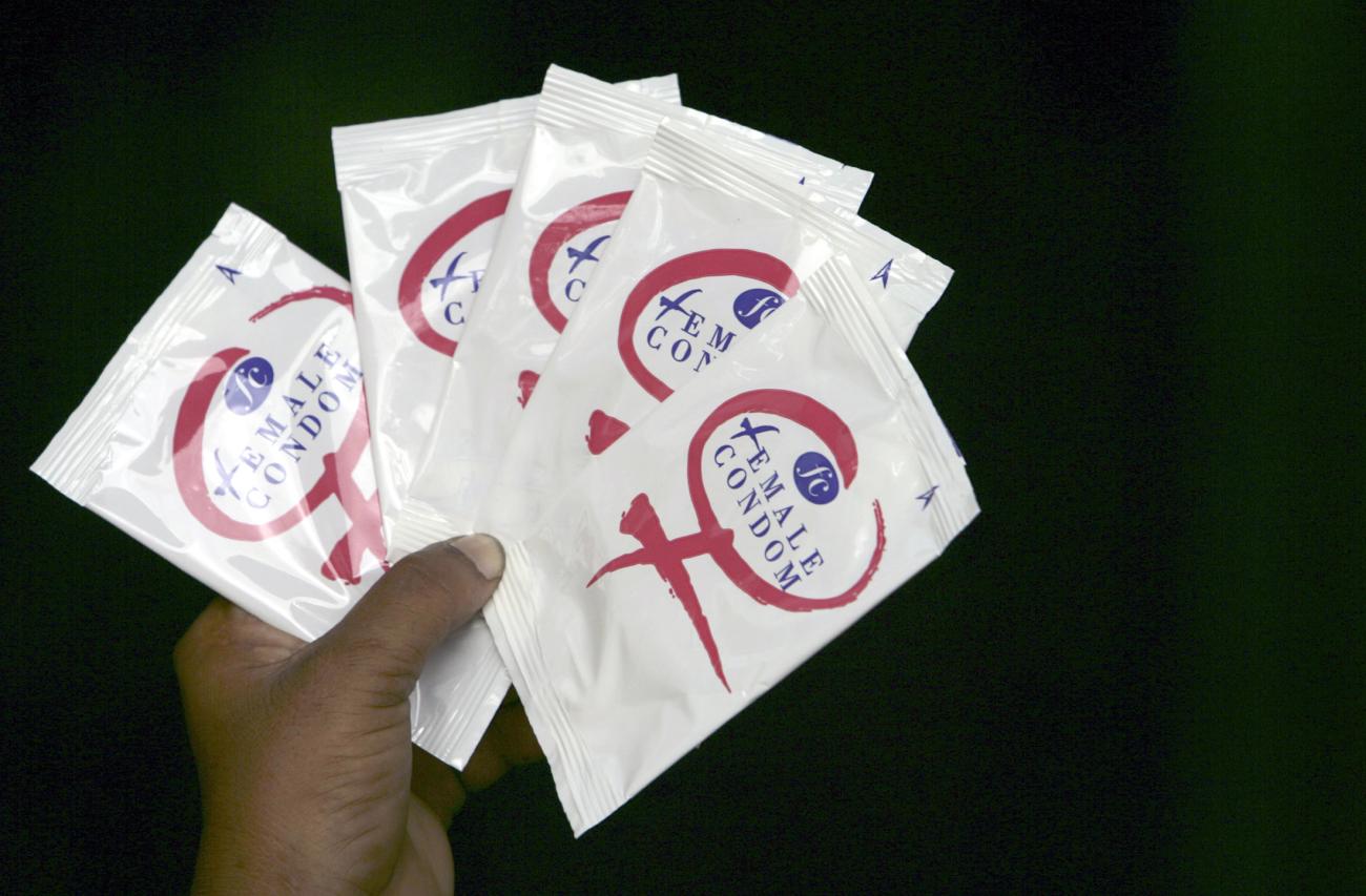 A sex worker holds packets of female condoms during an HIV/AIDS awareness campaign at a red-light area in the northeastern Indian city of Siliguri on July 6, 2007.